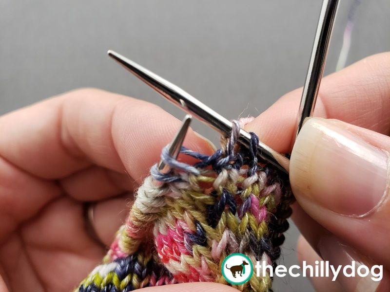 Working an extra stitch into the row or round  below.