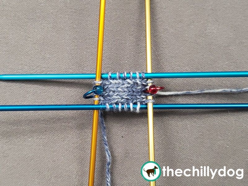 Rather than knitting around the cast on stitches, you start by knitting a small rectangle.